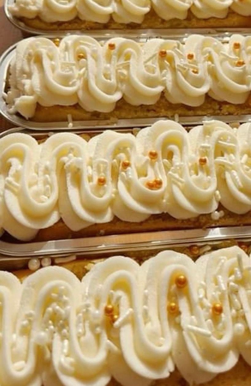 Vanilla eclairs with gold pearl accents
